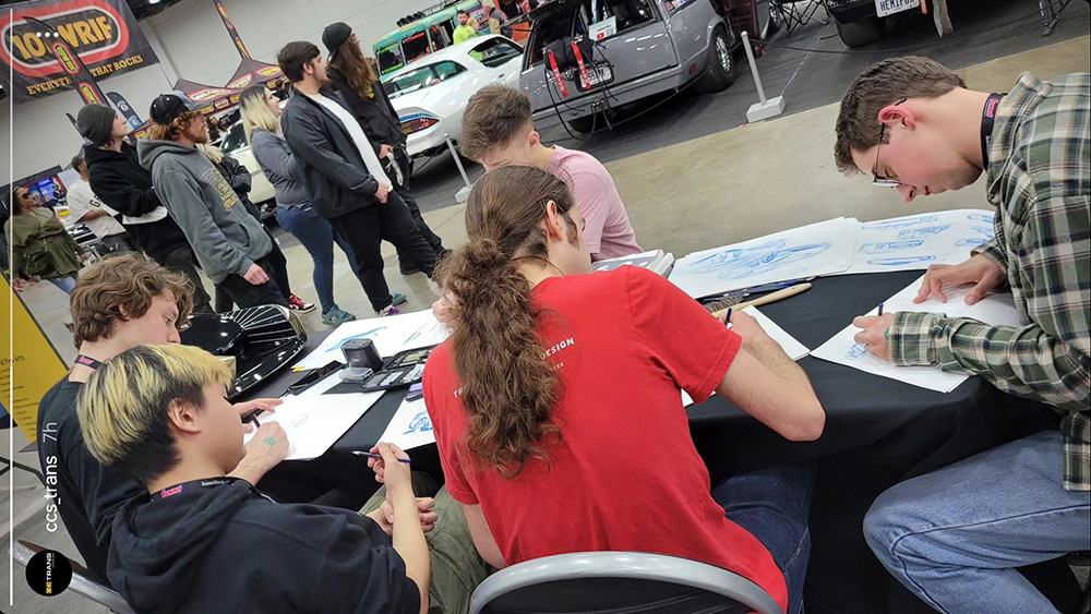 Me and other students sketching cars at the CCS booth at Autorama 2024.