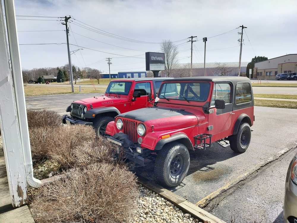 Newer Jeep Willys parked next to my CJ-7 at the barber shop.