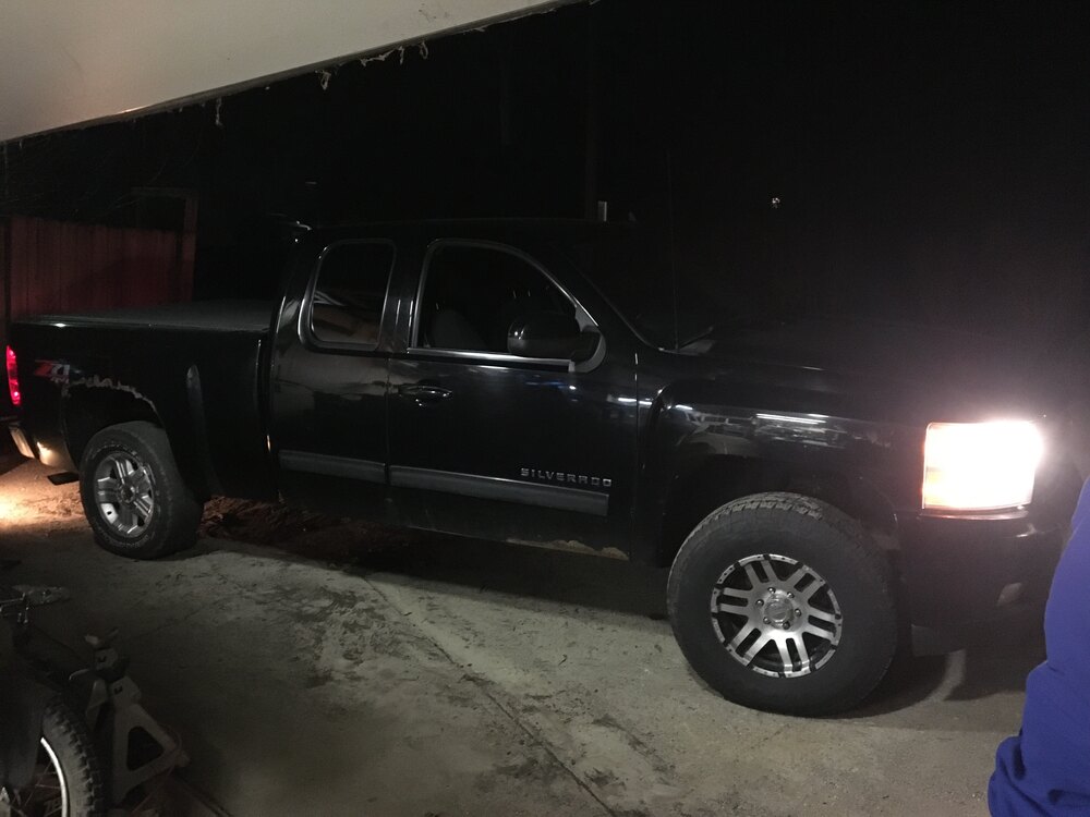 Side of the truck with new wheels fitted up front and original wheels in back.