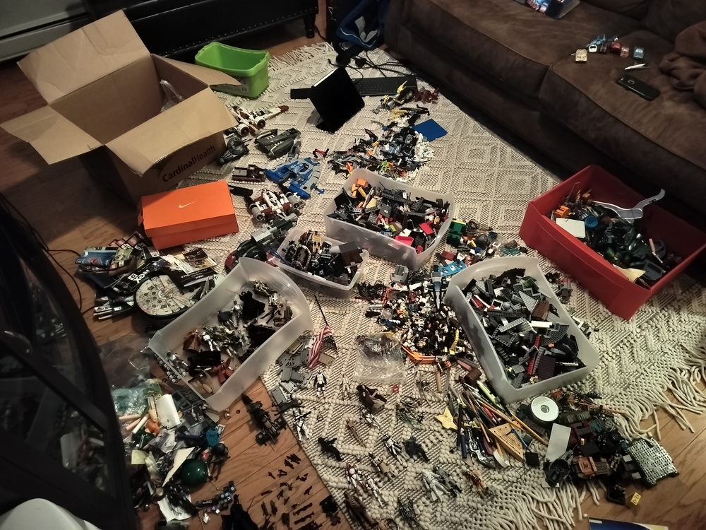 LEGO and action figures spread out across the livingroom floor.