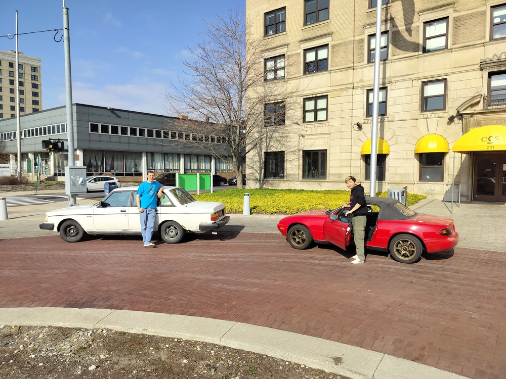 Ben and Rex in front of their cars, a 1989 Volvo 250 Sedan and 1997 Mazda MX-5.